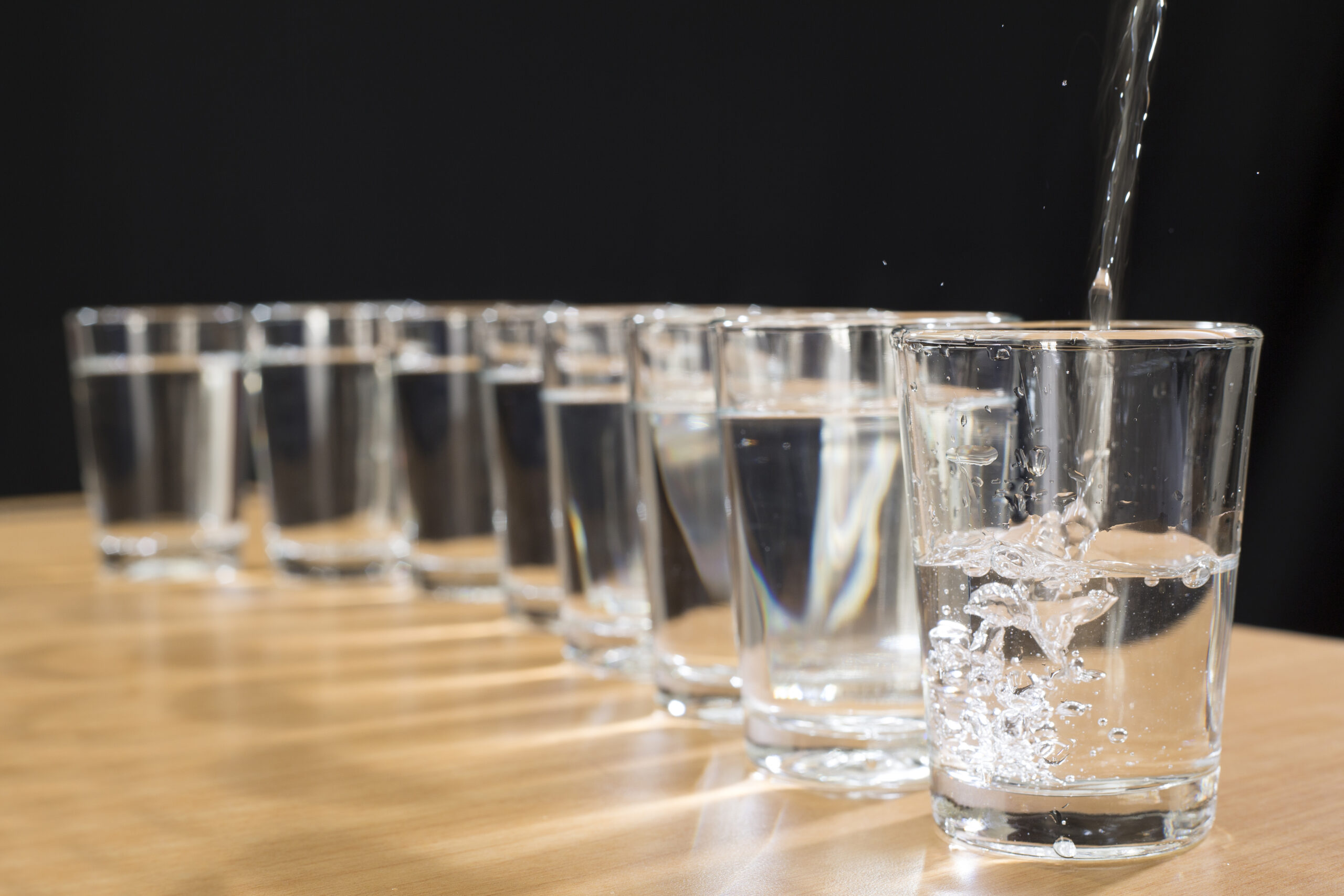 STOCK PHOTO: Eight glasses of water sit on a table. (iStock)